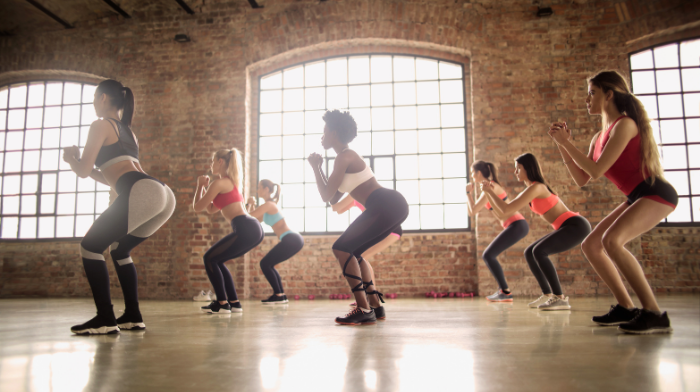 women squatting in a group fitness class