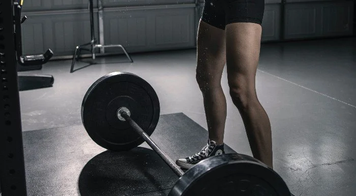 Close-up of a barbell loaded with heavy bumper plates