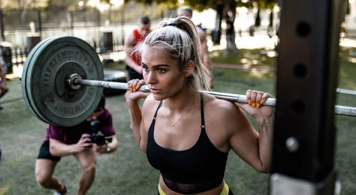 Person performing a heavy back squat in the gym
