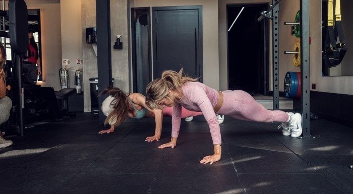 Woman performing a forearm plank on a mat