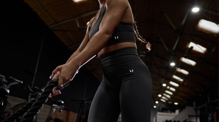 A woman in the gym lifting ropes during her "pull" day.
